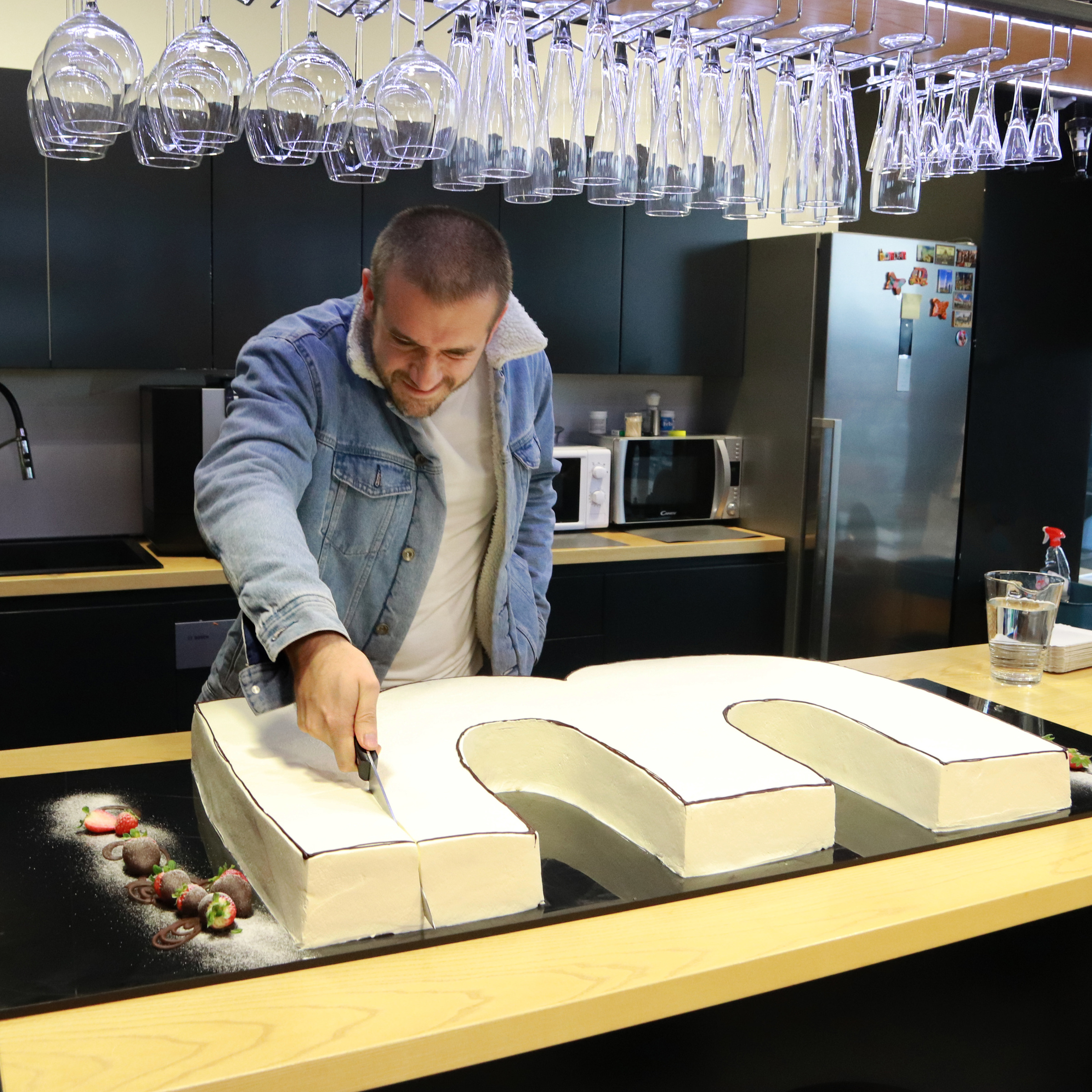 Infinum CEO Tomislav Car with a huge M-shaped cake