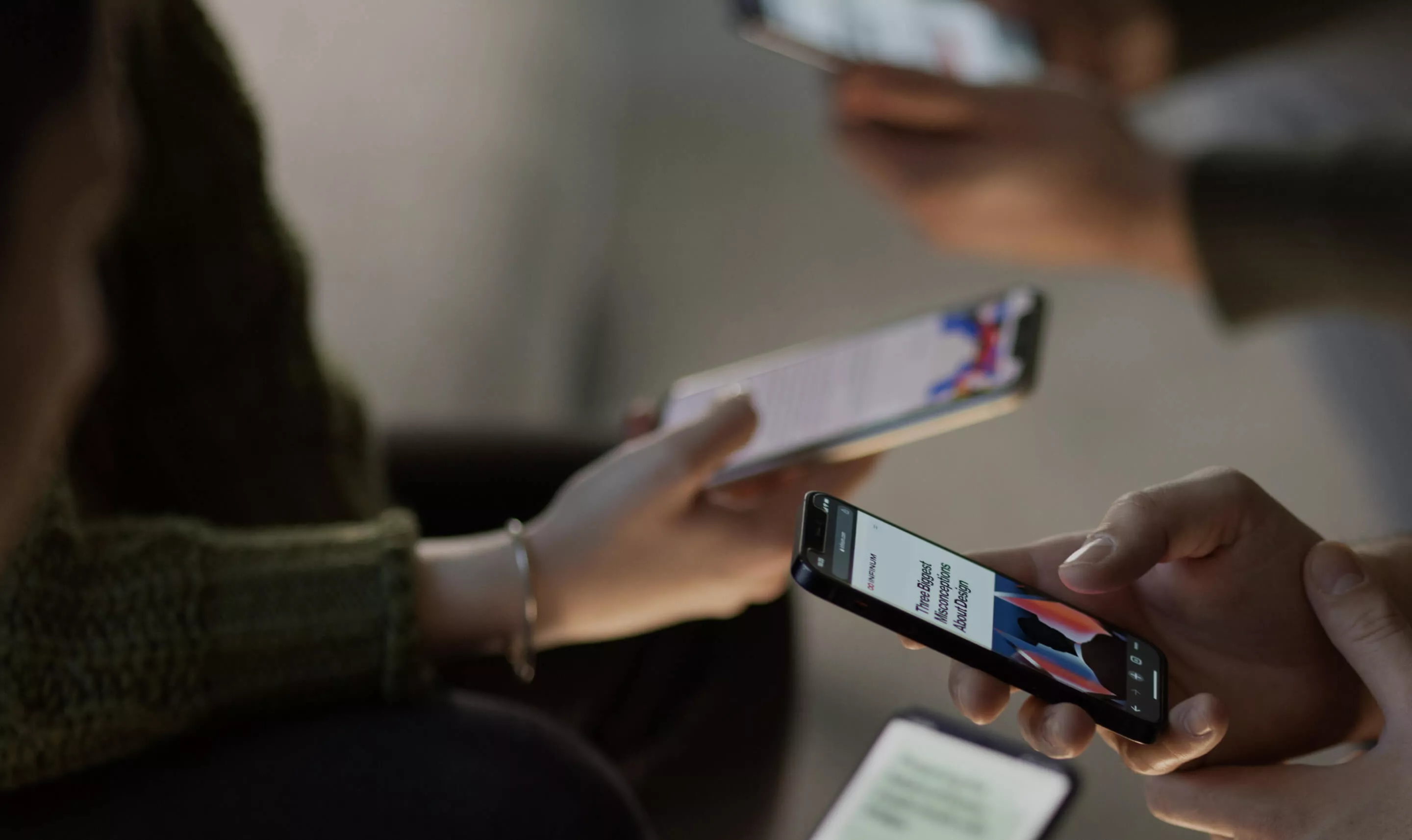 Team of professionals testing and reviewing apps for an enterprise mobile app development company.